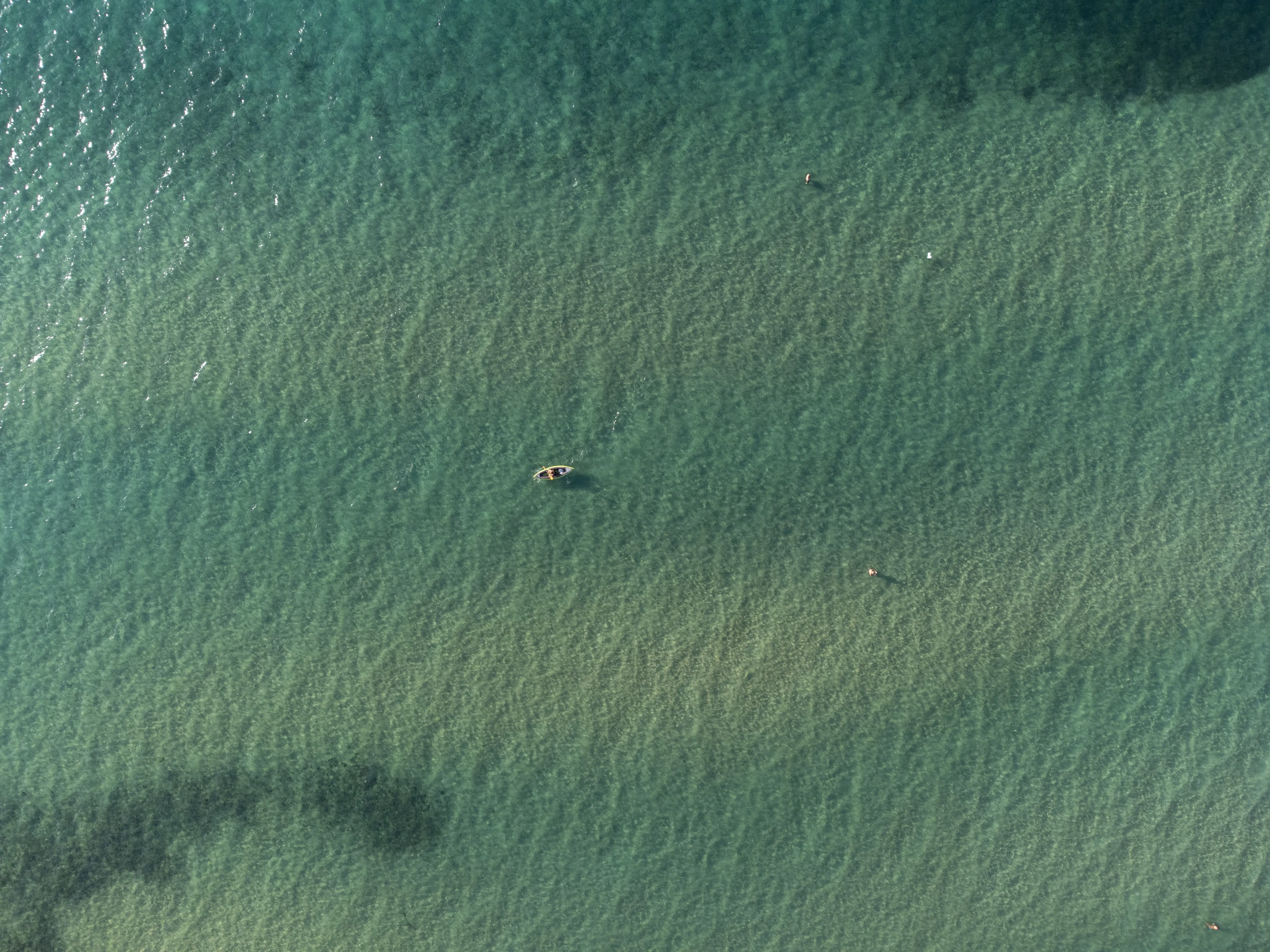 Aerial photo of calm and shallow beach waters